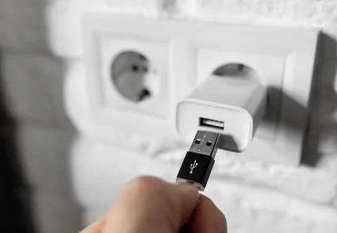 Unplugging USB cable from power adapter. Disconnect USB cord from the cellphone Stock Photos