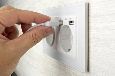 Unplugging USB cable from power adapter. Disconnect USB cord from the cellpho Stock Photos