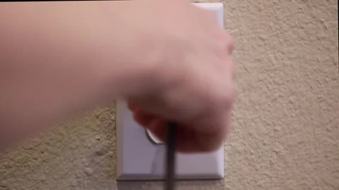 Unplugging wall socket Stock Footage 322191067