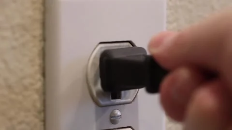 Unplugging wall socket - side Stock Footage 322191072