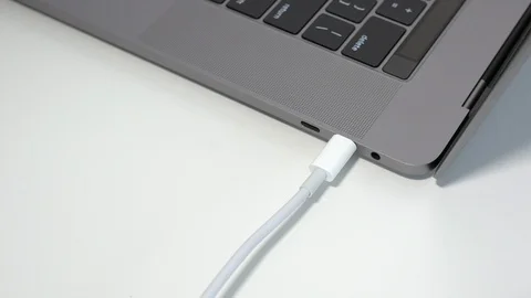 Unplugging a white USB-C / USB Type C cable from a notebook / laptop computer Stock Footage 95126587