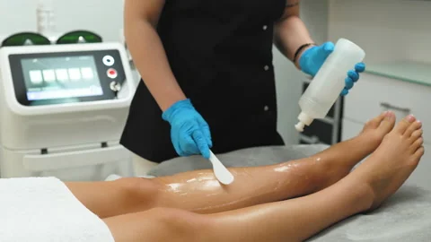 Unrecodgnizable client lying on a table and having a laser depilation procedure Stock Footage 227227143