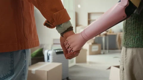Unrecognisable Man Joining Hands with Anonymous Girlfriend with Prosthesis Stock Footage 323299997