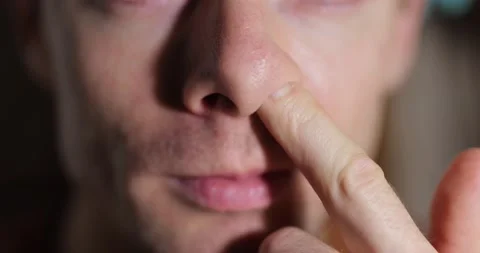 Unrecognisable man picking his nose with his finger Video stock 146470147