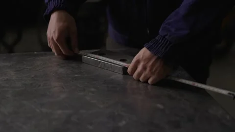 Unrecognisable person measuring metal piece Stock Footage 266950853