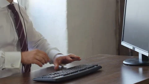 Unrecognisable worker sitting on office desk, taking his phone communication Stock Footage 143374533