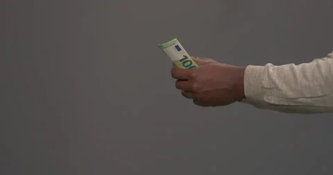 Unrecognizable African man with bundle of 100 euro banknotes. Male offering one Stock Footage 153282390