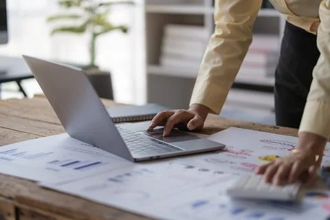 Unrecognizable analyst using laptop, analyzing sales statistics , taxes fin.. Stock Photos