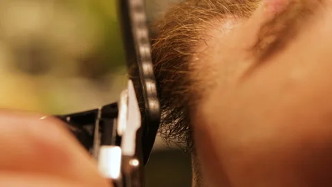 Unrecognizable Barber cuts beard of his male client using clipper and brush Stock Footage 98119755