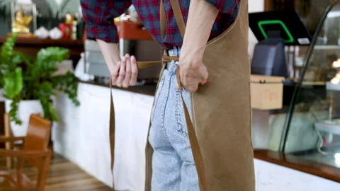 Unrecognizable barista female tie apron rope ready to work or open coffee s.. Stock Footage 246998853