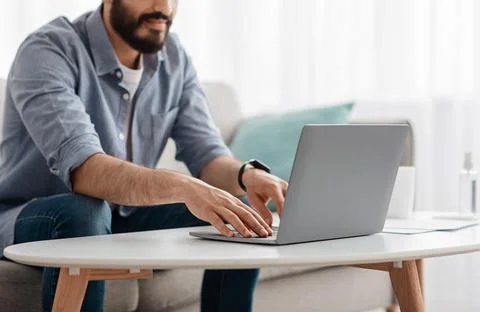 Unrecognizable bearded man working on pc, typing text or programming code on 写真素材