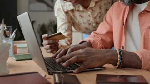 Unrecognizable Black Couple Purchasing Vacation Tickets Online with Card Stock Footage 333282933