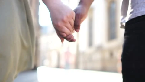 Unrecognizable black man and white woman hold each others hands. Close portrait Stock Footage 133644145