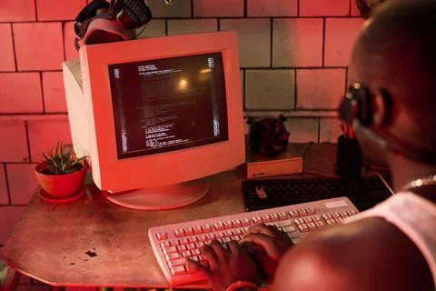 Unrecognizable Black Man Hacking Computer Program 写真素材