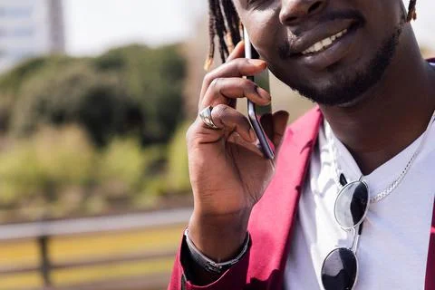 Unrecognizable black man talking on a smart phone Stock Photos