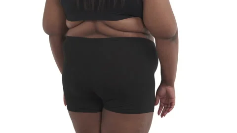 Unrecognizable black obese woman's back in underwear shaking her body isolated Stock Footage 134595692