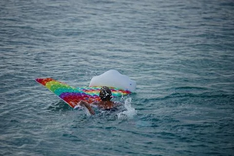 Unrecognizable boy floating on an inflatable mattress in the Adriatic Sea Stock Photos