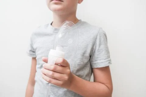 Unrecognizable boy holding an oxigen face mask in hand, pneumonia and lung de Stock Photos