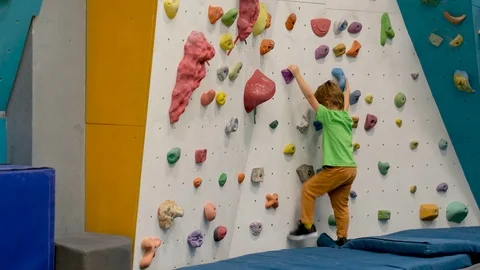 Unrecognizable boy practicing climbing in gym Video stock 126390915