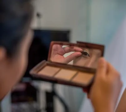 Unrecognizable bride checking her make up just before wedding start. Stock Photos