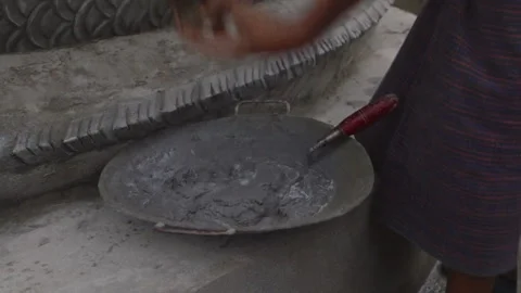 Unrecognizable builder mixing cement with a trowel Stock Footage 332764830