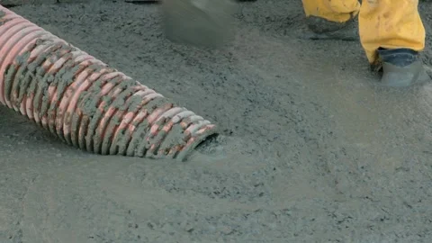 Unrecognizable builder pouring a concrete slab, spreading the concrete solution Stock Footage 284755910