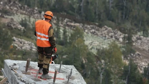 An unrecognizable builder stands Video stock 114883327