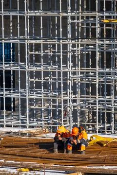 Unrecognizable builders using smartphones during break Stock Photos