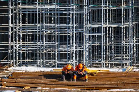 Unrecognizable builders using smartphones during break Stock Photos