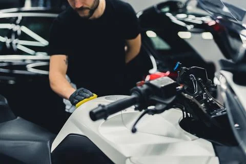 Unrecognizable car detailing expert using a sponge to deep clean white Stock Photos