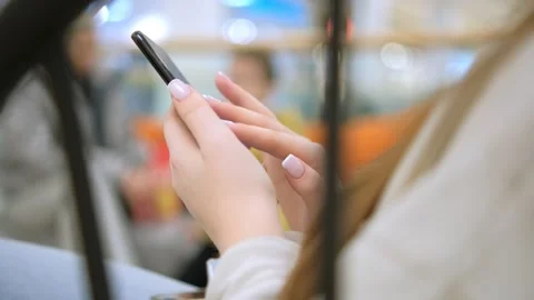 Unrecognizable caucasian female using her smartphone inside mall. Vertical Stock Footage 257689835
