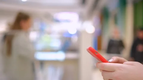 Unrecognizable caucasian female using her smartphone inside mall. Vertical Stock Footage 259036968