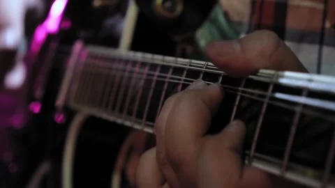 A unrecognizable Caucasian in rays of light plays on the rhythm guitar. Close-up Stock Footage 131548071