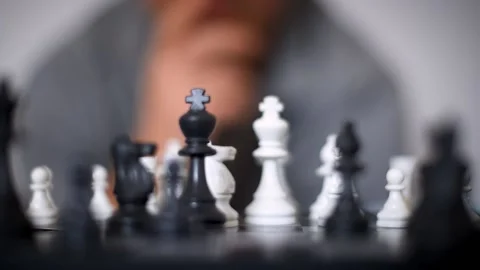 Unrecognizable chess player move the king forward on a chessboard. Stock Footage 212955914