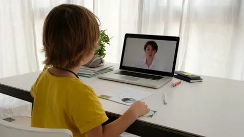 Unrecognizable child having video call with teacher on laptop indoors Vídeos de archivo 135314651