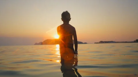 Unrecognizable child looking at infinity on the beach Stock Footage 265063924