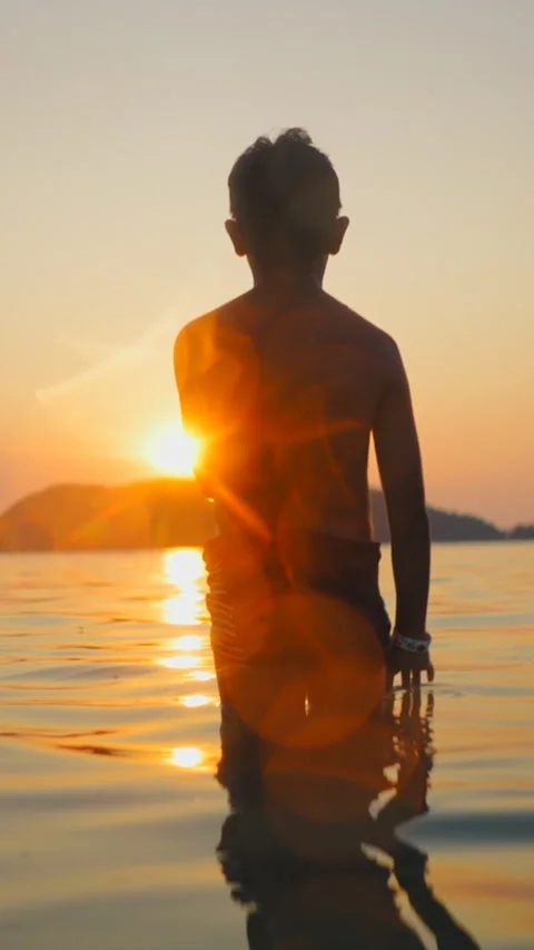 Unrecognizable child looking at infinity on the beach Stock Footage 265576396