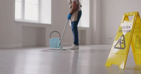Unrecognizable cleaner or janitor mopping empty office room with mop, doing Stock Footage 325180209