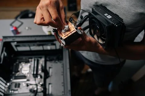 Unrecognizable computer technician wiping processor heatsink with microfiber Stock Photos