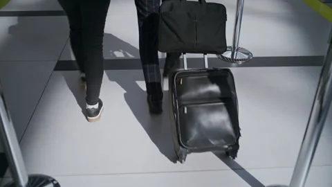 Unrecognizable Couple from Above Walking Together Through Airport Corridor Video stock 334566860