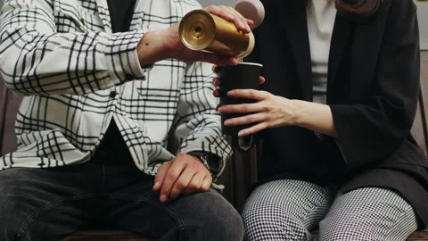 Unrecognizable couple is sitting on a bench, a man in a white flannel shirt Stock Footage 234062099