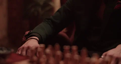 Unrecognizable crop man at table with chess pieces Stock Footage 260559669
