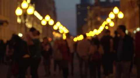 Unrecognizable crowd of people walking around night city in light of street Stock Footage 82762748