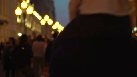 Unrecognizable crowd of people walking around night city in light of street 動画素材 83667203