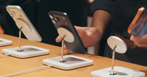 Unrecognizable customer examines new iPhone 17 Pro lineup in Apple Store Stock Footage 322050937