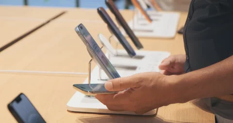 Unrecognizable customer explores new iPhone 17 Air lineup in Apple Store Stock Footage 322051055