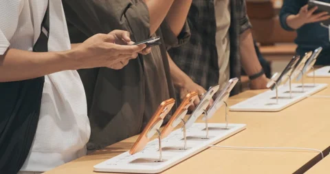 Unrecognizable customers test iPhone 17 lineup at Apple Store. Hands-on  Stock Footage 322051712