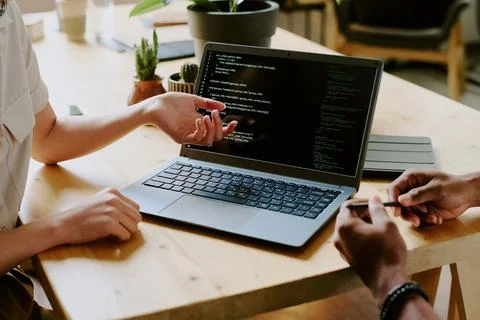 Unrecognizable Developers Working On Code 库存照片