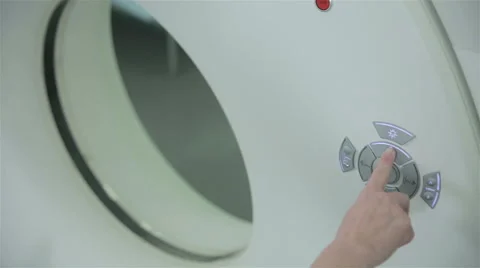 Unrecognizable doctor hands operates with Computerized Tomography CT MRI Scanner Video stock 66356241