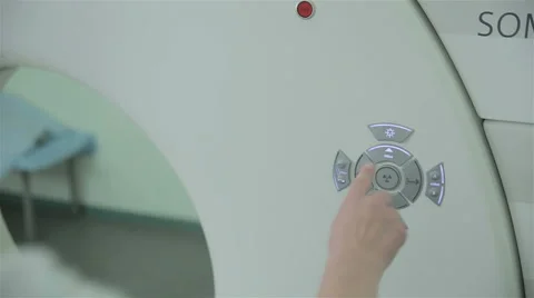 Unrecognizable doctor hands operates with Computerized Tomography CT MRI Scanner Stock Footage 66356405